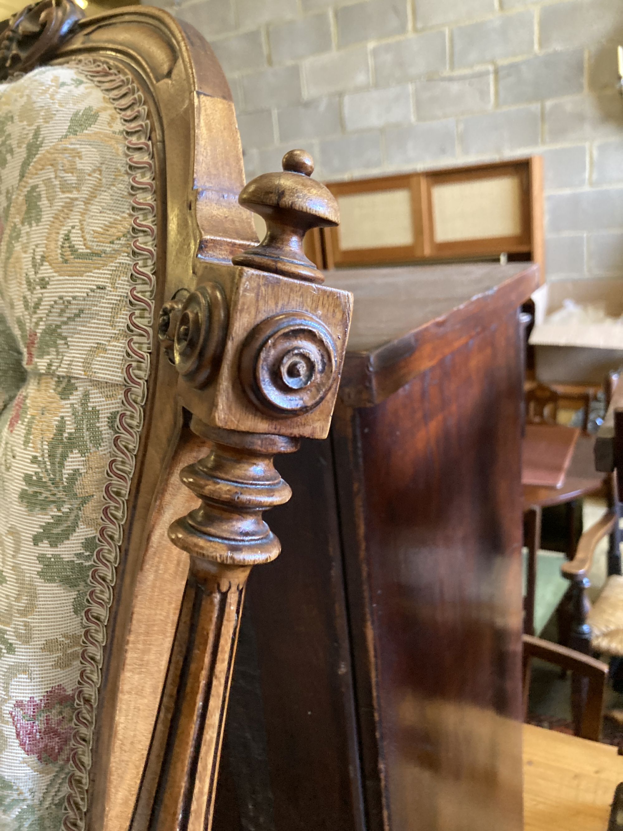 A Victorian carved walnut spoon back nursing chair, width 54cm, depth 56cm, height 80cm